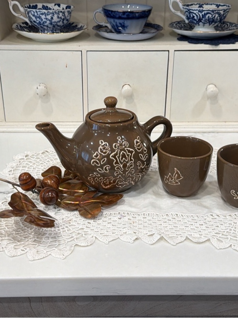 Brown Ceramic Teapot and Cup Set with White Floral Pattern